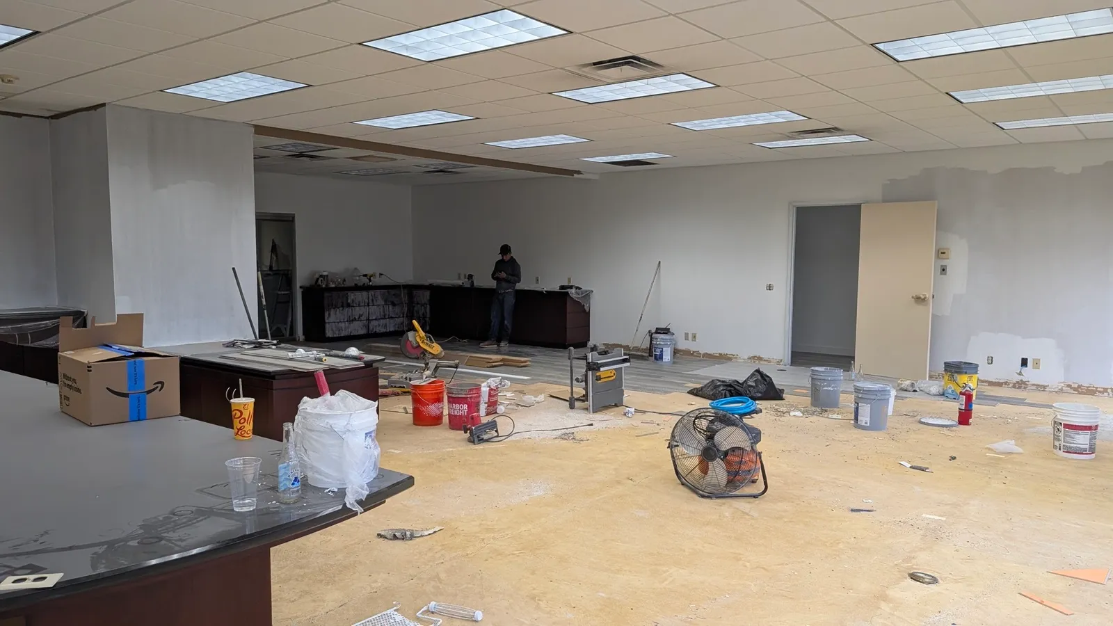 A commercial suite stripped back to bare concrete and framing at the demolition stage